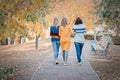 Cheerful attractive three young women best friends walking and having fun together outside.