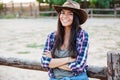 Cheerful attractive young woman cowgirl standing with arms crossed Royalty Free Stock Photo