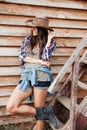 Cheerful attractive young woman cowgirl standing and smiling Royalty Free Stock Photo