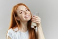 Cheerful awesome female with yogurt posing to the camera