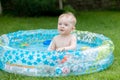 Portrait of cheerful baby boy enjoying swimming in inflatable swimming pool Royalty Free Stock Photo
