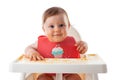 Cheerful baby child eats food itself with hands. Portrait of happy dirty kid boy in high chair and messy  around Royalty Free Stock Photo