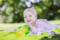 Cheerful baby girl with bottle of water in summer park Royalty Free Stock Photo