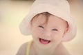 Cheerful baby girl with Downs Syndrome playing in the pool Royalty Free Stock Photo