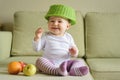 Cheerful baby girl plays with fruits at home Royalty Free Stock Photo