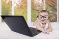 Cheerful baby and laughing with laptop Royalty Free Stock Photo