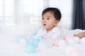 Cheerful baby playing color ball on bed Royalty Free Stock Photo