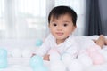 Cheerful baby playing color ball on bed Royalty Free Stock Photo