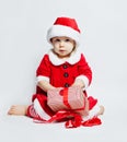 Cheerful baby in Santa hat opening Christmas gift box Royalty Free Stock Photo