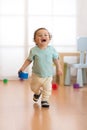 Baby toddler running indoors Royalty Free Stock Photo