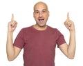 Cheerful bald guy pointing his fingers up. Isolated