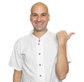 Cheerful bald man pointing finger. Isolated