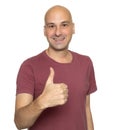 Cheerful bald man showing his thumb up. Isolated