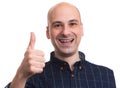 Cheerful bald man showing thumbs up