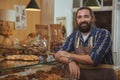 Cheerful bearded baker enjoying working at his store Royalty Free Stock Photo