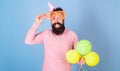 Cheerful bearded man with big smile wearing enormous glasses and birthday cap. Happy hipster with trimmed beard and