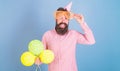 Cheerful bearded man with big smile wearing enormous glasses and birthday cap. Happy hipster with trimmed beard and