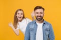 Cheerful bearded man in casual clothes have fun with cute child baby girl. Father little kid daughter isolated on yellow Royalty Free Stock Photo