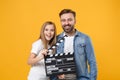 Cheerful bearded man have fun with child baby girl. Father little kid daughter isolated on yellow background. Love