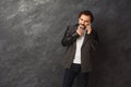 Cheerful bearded man talking on phone