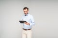 Cheerful bearded man using tablet computer. Happy handsome businessman working Royalty Free Stock Photo