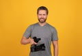cheerful bearded man videographer making movie for vlog with camcorder, video