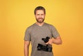 cheerful bearded man videographer making movie for vlog with camcorder, video