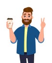 Cheerful bearded trendy man holding a coffee cup and showing, gesturing or making victory, V, peace sign with hand fingers. Royalty Free Stock Photo