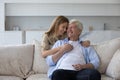 Cheerful beautiful adult daughter child hugging elder grey hair dad Royalty Free Stock Photo