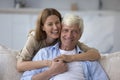 Cheerful beautiful adult daughter child hugging elder grey hair dad Royalty Free Stock Photo