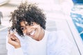 Cheerful beautiful and attractive young black african girl smiling and enjoying outdoo rleisure activity. Curly hair style and Royalty Free Stock Photo