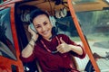 Cheerful beautiful female pilot showing thumbnail and expressing happiness