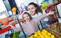 Cheerful beautiful mother and little girl choosing fresh fruits Royalty Free Stock Photo