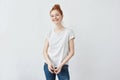 Cheerful beautiful redhead girl smiling. White background. Copy space.