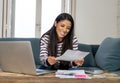 Cheerful beautiful woman paying bills online and managing budget feeling happy and relax Royalty Free Stock Photo