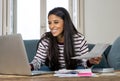 Cheerful beautiful woman paying bills online and managing budget feeling happy and relax Royalty Free Stock Photo