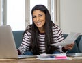 Cheerful beautiful woman paying bills online and managing budget feeling happy and relax Royalty Free Stock Photo