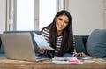 Cheerful beautiful woman paying bills online and managing budget feeling happy and relax Royalty Free Stock Photo