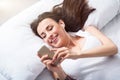 Cheerful beautiful woman resting in bed Royalty Free Stock Photo