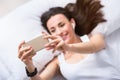 Cheerful beautiful woman resting in bed Royalty Free Stock Photo