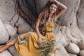 Cheerful beautiful young boho style model on the stone beach Royalty Free Stock Photo