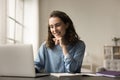 Cheerful beautiful young freelancer girl working at home