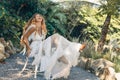 Cheerful beautiful young stylish boho woman at sunset