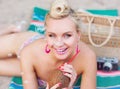 Cheerful beautiful young woman lying on the beach with vintage c Royalty Free Stock Photo