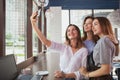 Beautiful female friends enjoying morning coffee at the cafe together Royalty Free Stock Photo