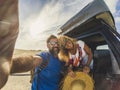 Cheerful beautiful youth adult caucasian couple enjoy and take a slefie picture with them and the car with tent on the roof - Royalty Free Stock Photo