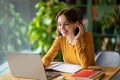 Cheerful young woman attending online business meeting, cafe interior Royalty Free Stock Photo