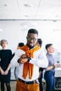 Cheerful black boss pointing at his watch