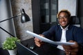 Cheerful black businessman passes the documents prepared on time