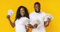 Happy african-american man and woman holding dollars Royalty Free Stock Photo